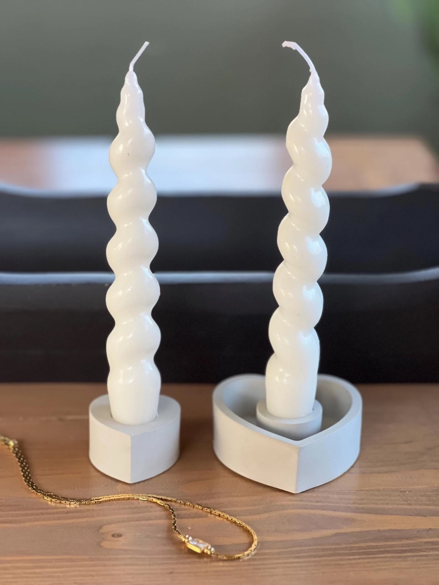 Twisted candles in modern concrete holders