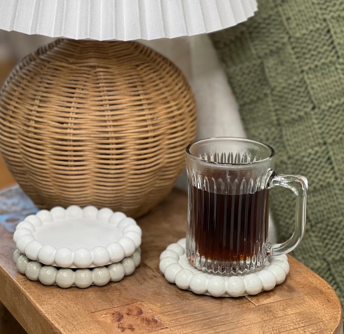 Concrete coasters styled with a glass mug