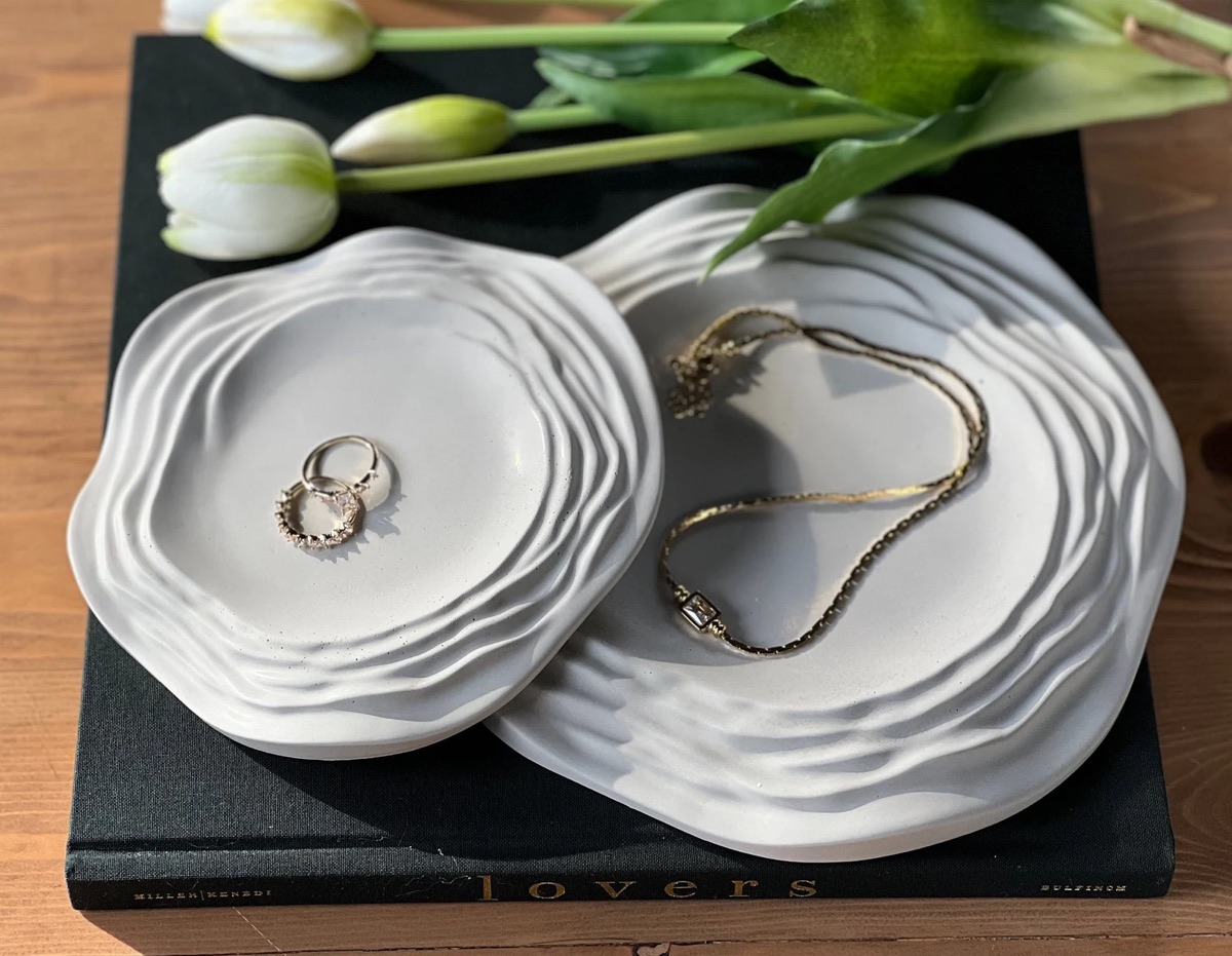 Wavy concrete trays styled with jewelry
